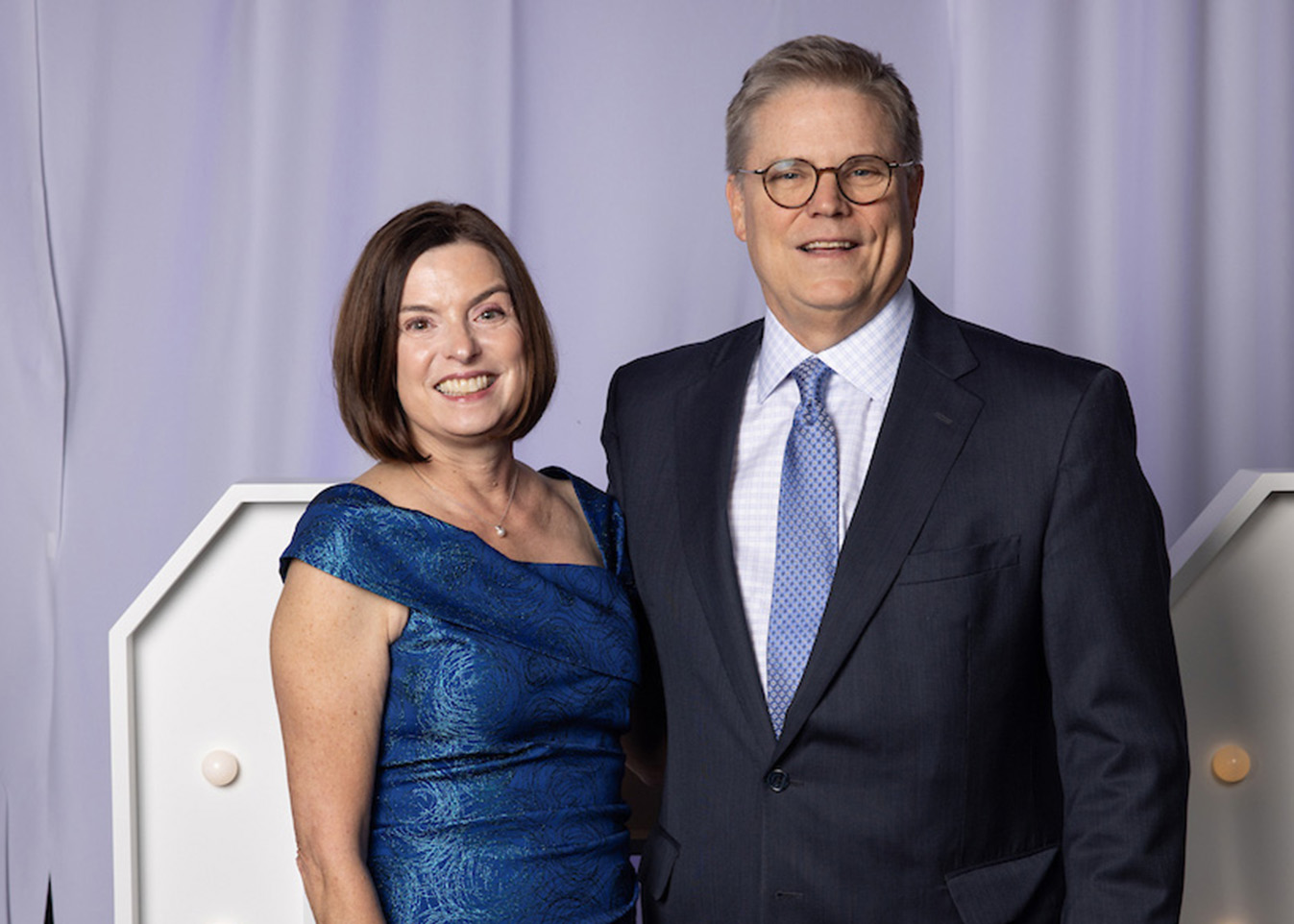 Kirk Hays is presented with a blue vase as a Vision Dinner 2025 Honoree