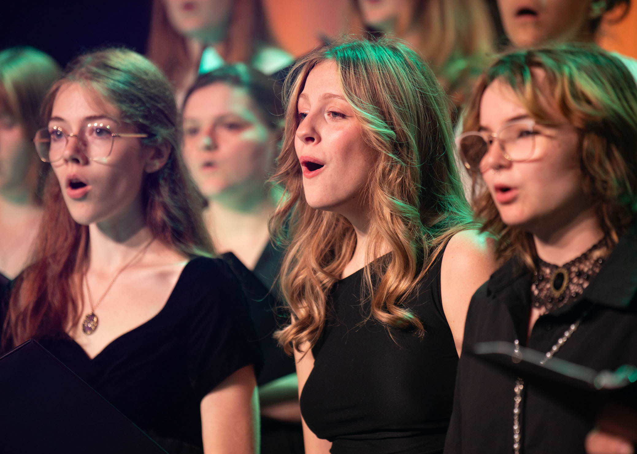 Three TCC choir members singing.